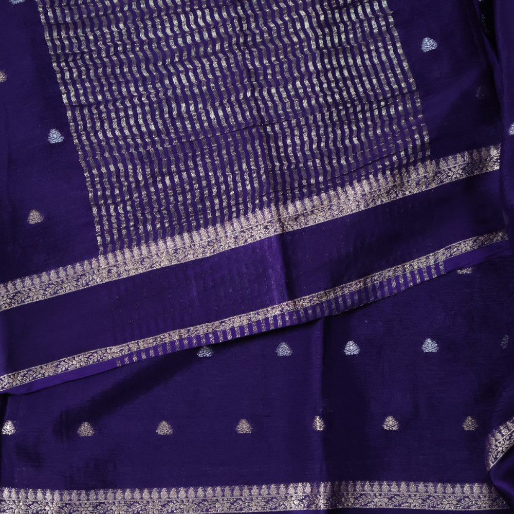 Close-up of a purple saree with white patterns and border